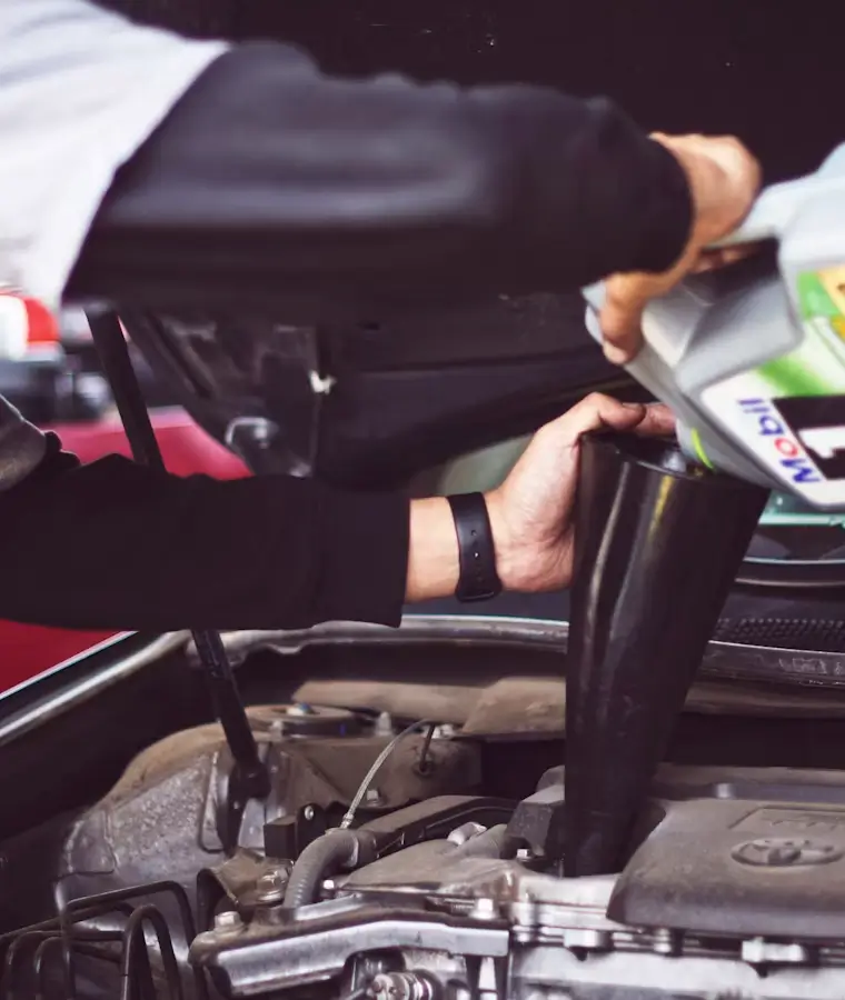 Technician carrying out general servicing on a vehicle engine